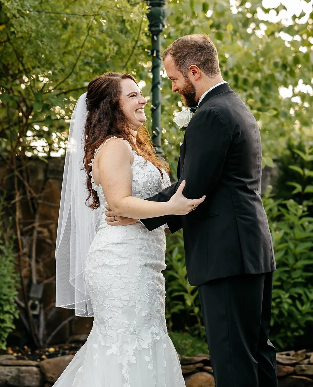 A happy bride and groom smiling at each other, captured by a professional wedding photographer in New England.